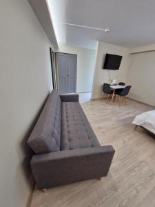 a living room with a couch and a table at Trevena Kretinga in Kretinga
