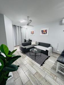 a living room with a couch and a table at Ushaka Ocean Escape - Shaka Shores 5E in Durban +32 photos