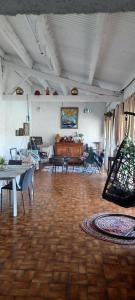 a living room with a wooden floor and a piano at La paillote des Ninous in Bassan