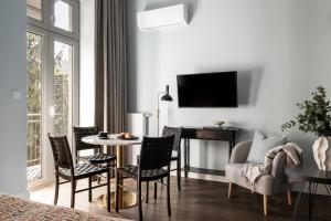 a living room with a table and chairs at Moja Apartments Krakow Old Town in Krakow