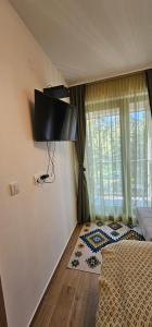 a bedroom with a bed and a large window at Valena 2 - Divčibare Free private Parking in Divčibare