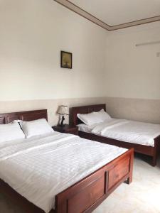 Postel nebo postele na pokoji v ubytování Magnolia Hotel Cam Ranh