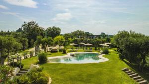 an image of a garden with a swimming pool at Privilegium Lazise in Lazise