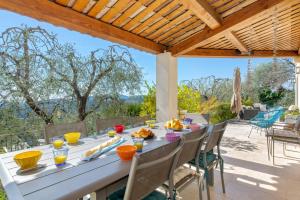 a table with food on it on a patio at Villa Bel Horizon by Villa Plus in Cabris