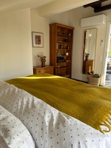 a bedroom with a bed with a yellow blanket on it at Stylish Two Bedroom Family Villa in Sopot