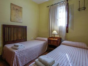 two twin beds in a room with a window at Andalusian Getaway Game of Thrones Castle in Posadas +23 photos