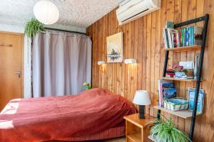 a bedroom with a bed and a book shelf at Beau Studio Vue Splendide 3 Vallées in Champoulet