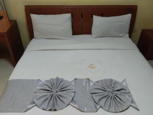 a bed with two bow ties on it at new raya hotel in Nairobi
