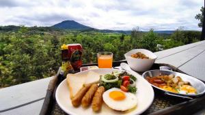 a plate of breakfast food on a tray on a table at TasVillaKhaokho ทัสวิลล่าเขาค้อ - Nordic Type in Phetchabun