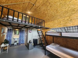 a room with two bunk beds and a bathroom at TasVillaKhaokho ทัสวิลล่าเขาค้อ - Nordic Type in Phetchabun