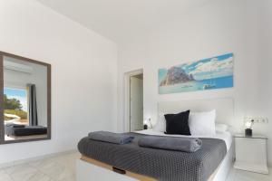 a bedroom with a bed and a large mirror at Villa Boutique Can Plana in Sant Jordi +42 photos