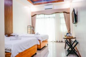Postel nebo postele na pokoji v ubytování Datahan Bayhaus Inn + 12 fotografií