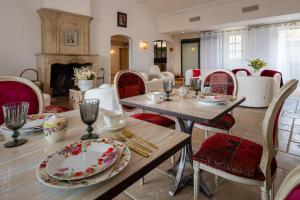 戈尔德Le Palais d'Aglaé, Hôtel de Charme的一间带桌椅和壁炉的用餐室