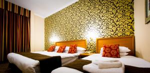 A bed or beds in a room at Best Western Queens Hotel 