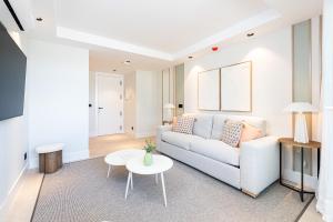 a living room with a couch and a table at iloftmalaga Puerto in Málaga +62 photos