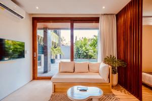坎古TheHub Pererenan Coworking, Pool and Rooftop的带沙发和桌子的客厅