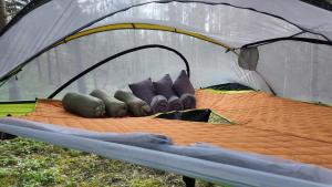 a group of pillows sitting in a tent at Tree tents Camping in Matuļi +11 photos