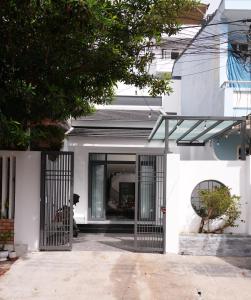 a house with a gate in front of it at Nhà Nhím in Da Lat