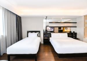 Rúm í herbergi á Crystal Orange Hotel Shanghai Kangqiao Branch