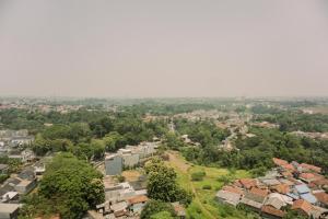 an aerial view of a city with houses and trees at Simply Look Studio at Parkland Avenue Apartment By Travelio in Tangerang