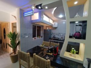 a kitchen with a table and chairs in a room at Mini villa dakhla in Dakhla