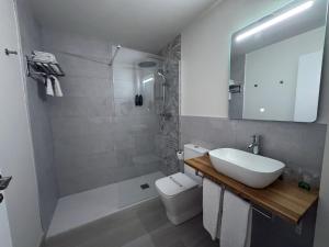 a bathroom with a sink and a toilet and a mirror at Hotel ELE Acueducto in Segovia +65 photos