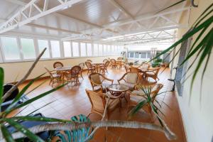 a room with tables and chairs in a building at Hotel O Cruceiro in Caldas de Reis
