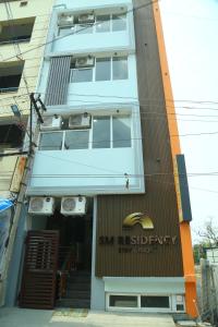 een gebouw met een bord aan de voorgevel bij S M Residency in Tiruppūr