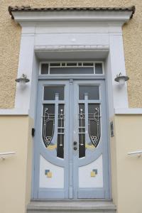 a blue door on the side of a building at Apartment Two am Stadtpark in Villach