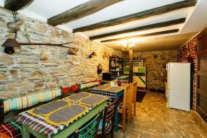 Una cocina con dos mesas y un refrigerador. en Къща за Гости Марго, en Kosti