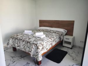 a bedroom with a large bed with a wooden headboard at Bungalow privado junto al Yumbo Centre in San Bartolomé de Tirajana +58 photos