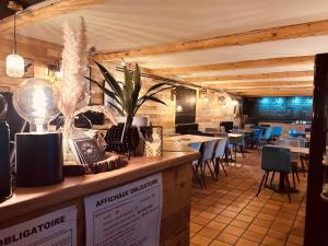 a restaurant with a bar with tables and chairs at Le Ristolas in Ristolas