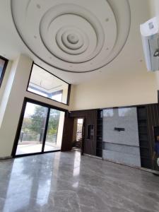 a large room with a ceiling with a spiral at Sunrise vista Near expo center in Greater Noida