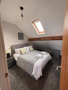 a bedroom with a bed with two towels on it at Stylish Coastal Apartment with Breathtaking views in Conwy