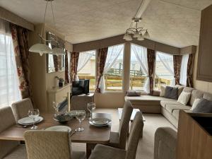 a living room with a table and chairs and a couch at New Hampton 36 in Dunoon