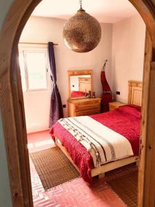 a bedroom with a bed and a mirror at Darnejma Guesthouse Oualidia in Oualidia +21 photos