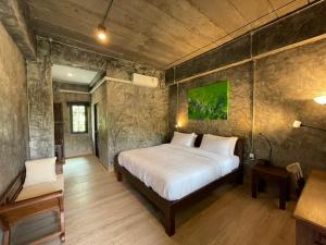 Postel nebo postele na pokoji v ubytování วิลลา วาดี แม่กำปอง Villa Vadee Maekampong