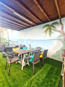 a dining room with a table and chairs and a beach mural at Mamas Summer House in Larnaca