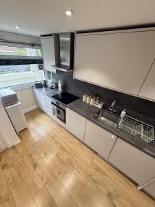 a kitchen with a sink and a counter top at Luxury 3BDR apartment in King’s cross in London