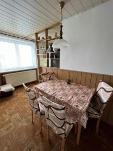 a dining room table and chairs in a room at Apartmán Za kostelem in Zvole
