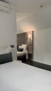 a living room with a bed and a couch at Hôtel Rohan Strasbourg in Strasbourg