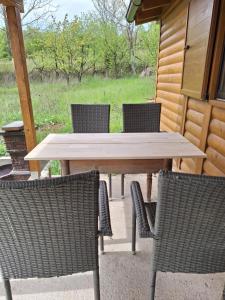 a wooden table and chairs on a patio at Jos 5 minuta in Jagodina