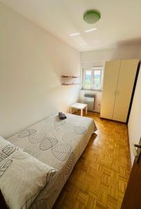 a bedroom with a bed and a wooden floor at Apartment Piranesi with a parking space in Pula