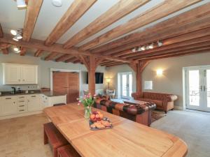 a kitchen and living room with a wooden table at The Barn in York