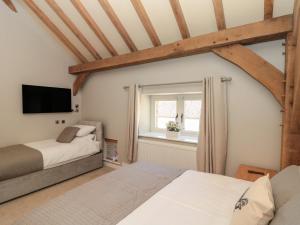 a bedroom with two beds and a window at The Barn in York +48 photos