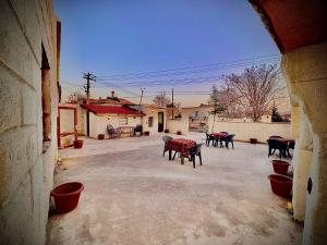 a courtyard with tables and chairs in a building at Evra Cappadocia Hotel in Nevşehir +13 photos