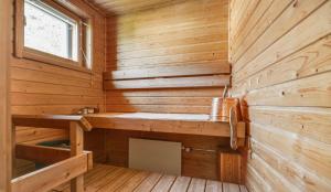 a sauna with wooden walls and a window at Helsinki Hallainvuori yksityismajoitus in Helsinki