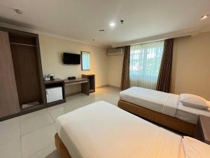 Postel nebo postele na pokoji v ubytování Manise Hotel