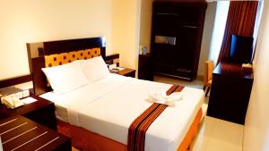 Postel nebo postele na pokoji v ubytování Manise Hotel