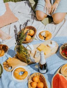 a person sitting on a table with food on it at Camping - Piscine - ccbbaah in Quinson
